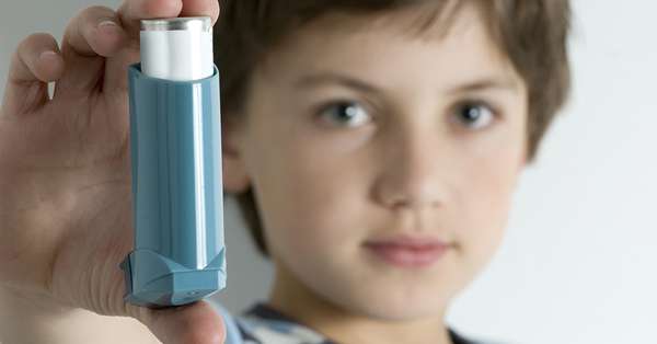 Child with inhaler referencing asthma