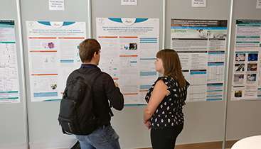 People looking at the Conference poster catch-up